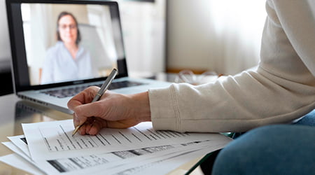 Learner taking notes during a remote lesson